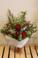 Mixed Christmas Flower Bouquet with Red Roses and Thistle Available for local delivery in Cheadle and Stockport